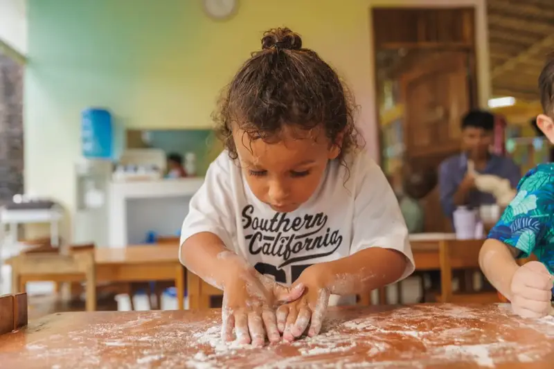 A child kneading dough