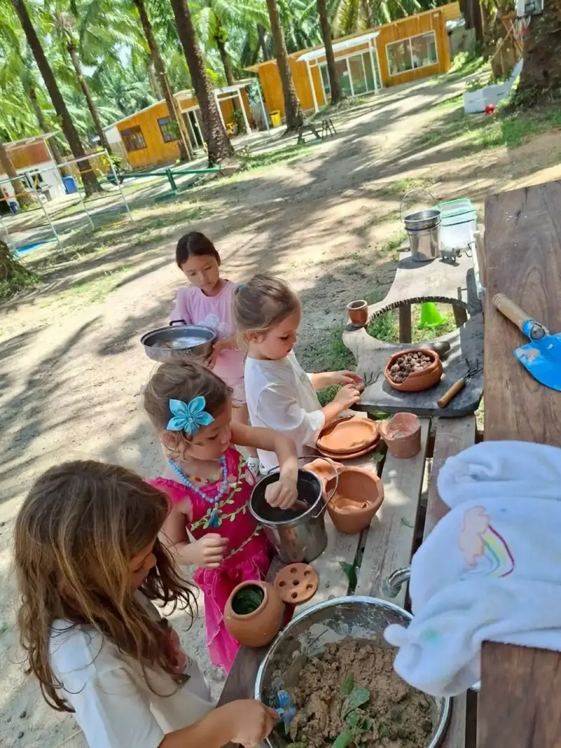 Girls cooking at the mud kitchen